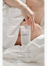 Hand holding a tube of Lagom skincare product with text about morning facial wash and pore care.