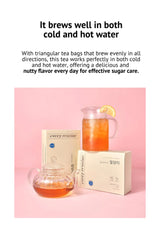 Tea packaging with a teapot and lemon on a pink background