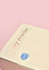 Notebook with 'Every Routine' text and Two Safes logo on a pink background