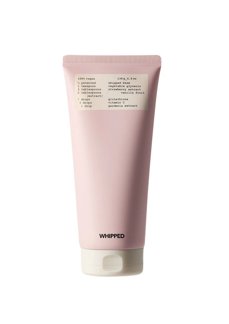 Pink tube of whipped product with a label on a white background