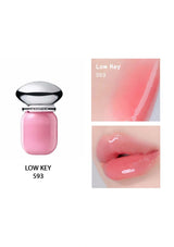 Pink lip gloss with a silver cap, shown in a bottle and on lips, on a white background.