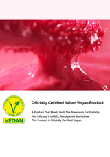 Red liquid being poured with a certification label for an Italian vegan product.