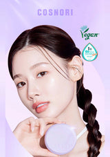 Woman holding a purple cosmetic product with 'Cosnori' branding and 'Vegan' certification on a light purple background.