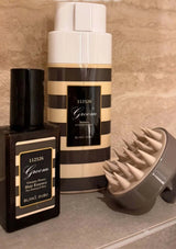 Two hair care products with striped design on a textured surface