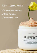 Jar of skincare product with a yellow flower on a beige background, featuring key ingredients text.