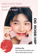 Advertisement for a cosmetic product with a person holding a pink container labeled '06 Rose Hip'.