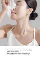 Woman applying cream to face with a white background