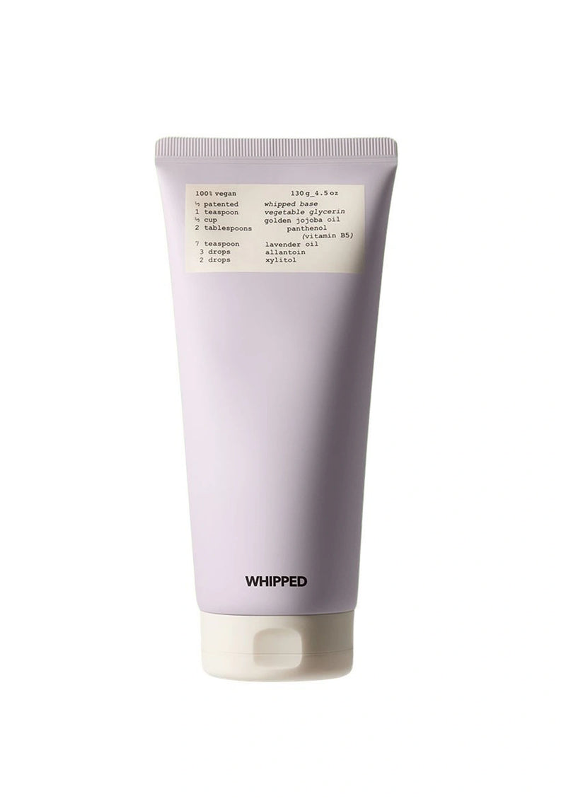 Purple tube of whipped product with a white label on a white background