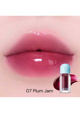 Lipstick with '07 Plum Jam' shade on a close-up of lips, with a bottle of lipstick below.