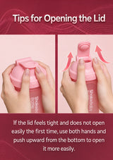 Instruction graphic titled 'Tips for Opening the Lid' showing two close-up views of hands opening a pink shaker bottle. The left panel shows the lid being pressed, and the right panel shows the lid popping open with arrows indicating upward pressure.