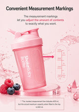 Pink ShakeBaby shaker bottle with measurement markings, shown on a pink background with text explaining the measurement feature and a small capacity diagram.