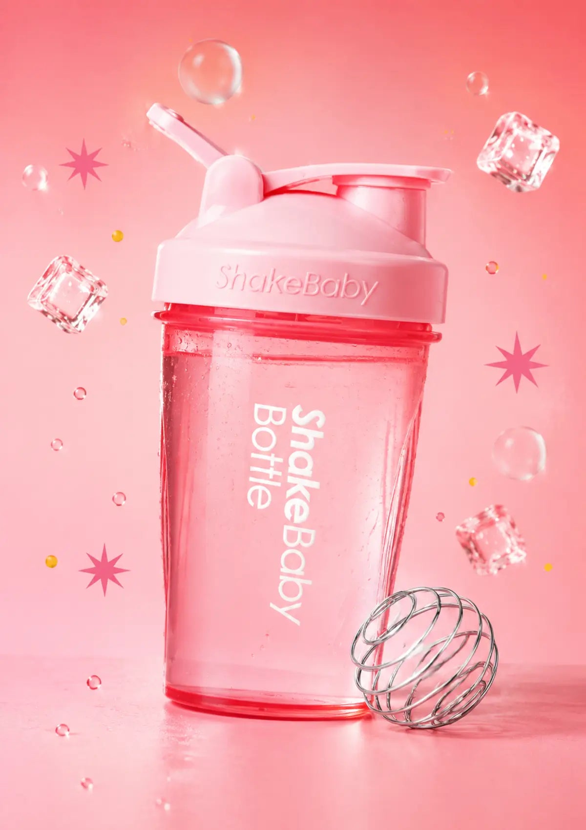 Pink Shakebaby shaker bottle with a flip-top lid and straw, shown on a solid pink background with the text 'SHAKE BABY SHAKER BOTTLE' at the top and a wire whisk illustration at the bottom right.