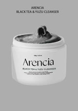 Arencia Black Tea & Yuzu Cleanser jar with gray cleanser on a gray background