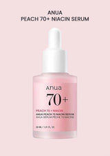Anua Peach 70+ Niacin Serum bottle on a light pink background