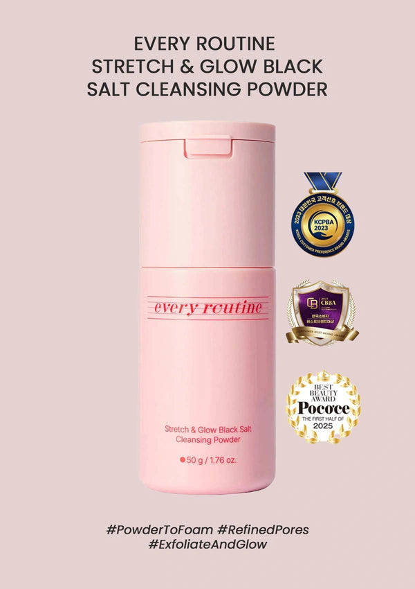 Pink bottle of 'Every Routine' stretch and glow black salt cleansing powder on a light pink background with certification logos.
