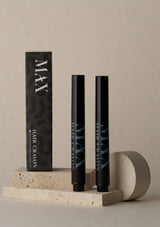 Black hair crayon packaging with 'MAX' branding on a neutral background