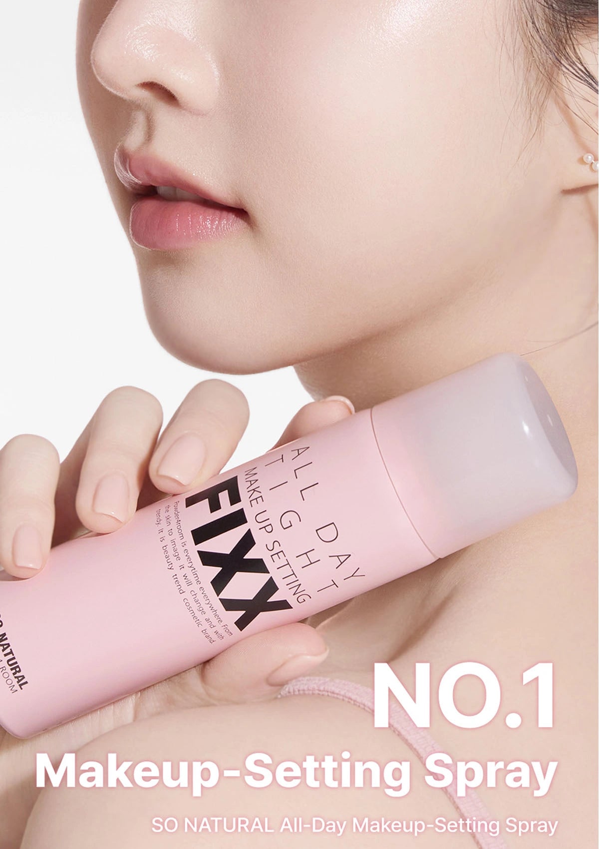Makeup-setting spray bottle held by a person with a blurred background