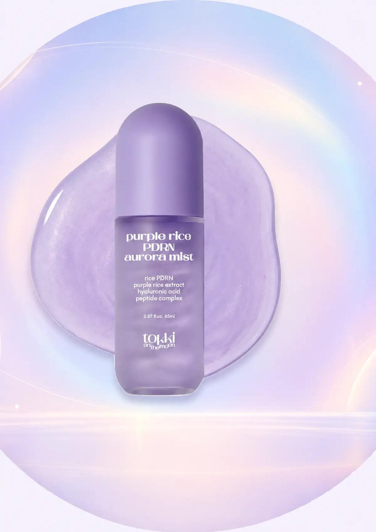 A bottle of topj i cosmetics 'purple rice PDRN aurora mist' in a lavender-purple color, set against a stylized circular background with a soft iridescent rainbow glow.