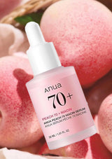 Anua peach 70+ niacin serum bottle with peaches in the background
