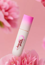 Lip balm with 'I love you' text on a pink floral background