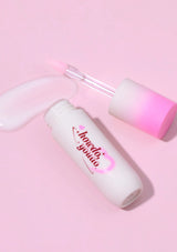 Skincare bottle with pink cap on a pink background
