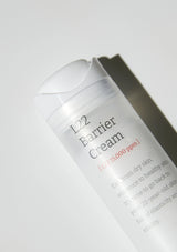 L22 Barrier Cream container on a light gray background
