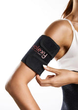 Person wearing a black Volexy arm brace on a white background