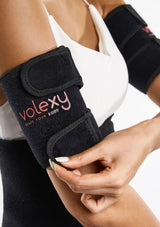 Person wearing a black wrist support brace with 'volexy' branding on a white background