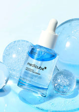 Medicube serum bottle with dropper on a light blue background