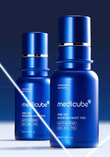 Two blue Medicube skincare bottles on a dark background