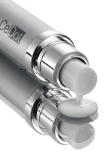 A close-up studio shot of a silver cosmetic tube with a metallic pump dispensing white cream, with the brand name CeDot partially visible on the tube.