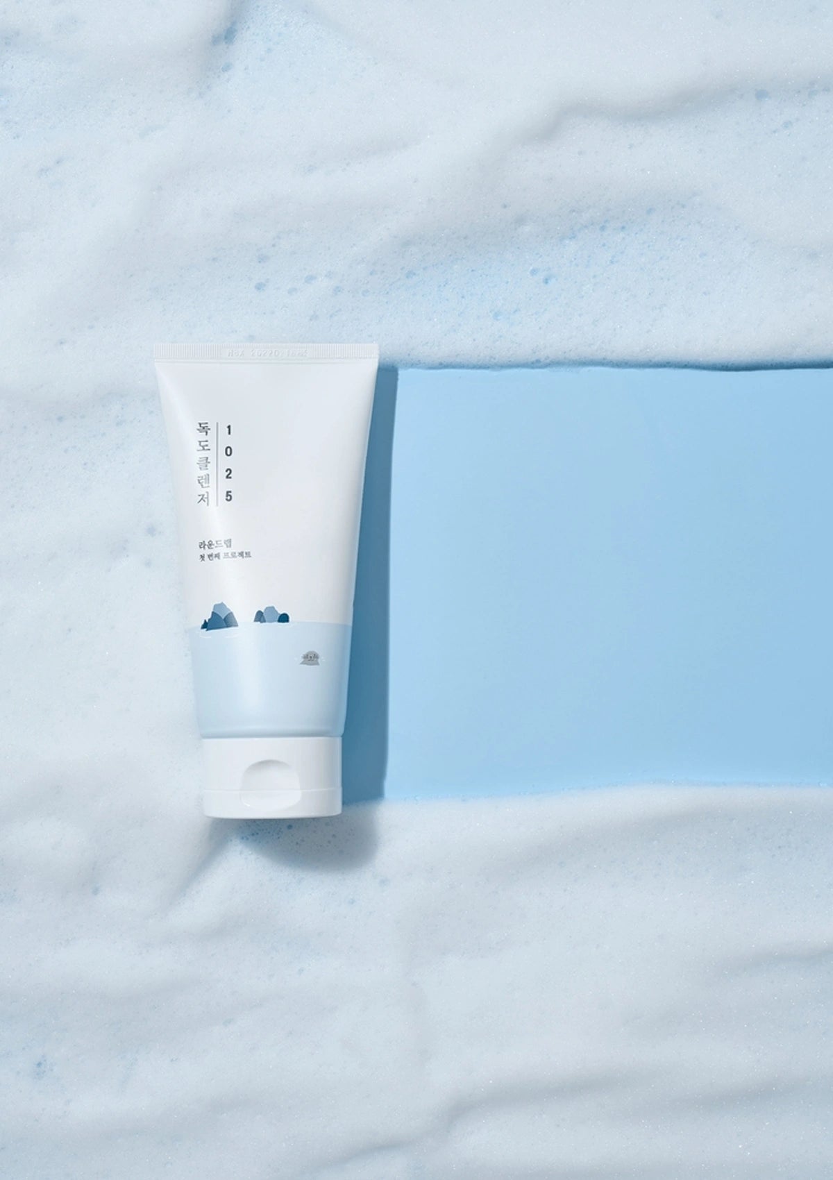 Tube of cream on a light blue fabric background