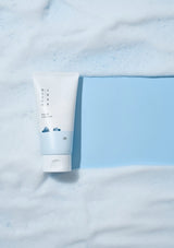 Tube of cream on a light blue fabric background