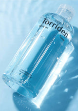 Torriden toner bottle on a light blue background
