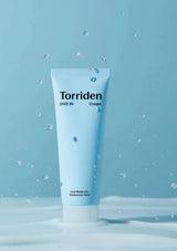 Torriden cream tube on a blue background with water droplets