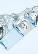 Medicube product wrapped in clear plastic with water splashes on a light blue background