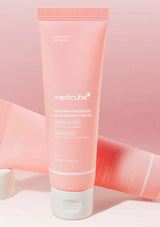 Pink tube of Medicube cream on a pink background