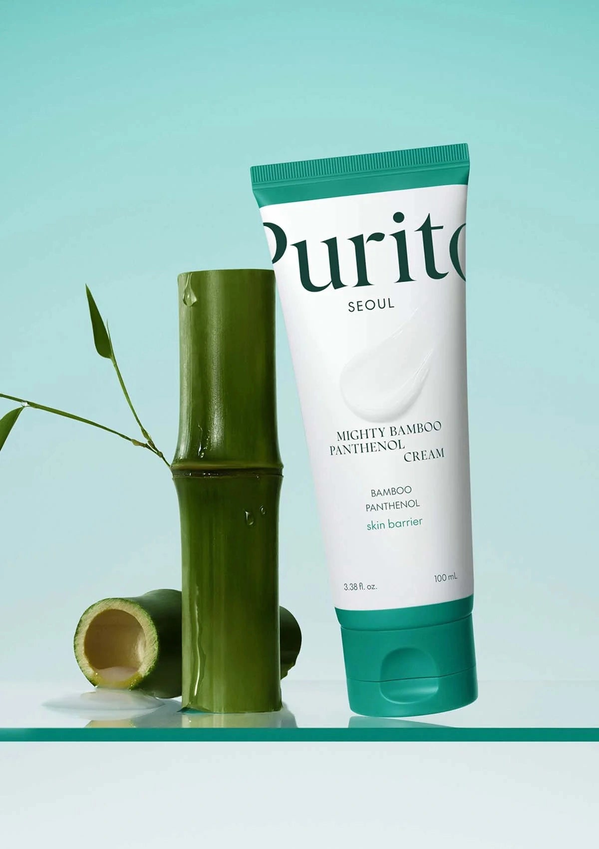 Tube of Purito Mighty Bamboo Panthenol Cream with a bamboo stick on a light blue background