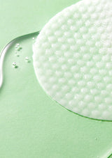 Close-up of a white scrubber on a green background