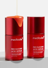 Two red bottles of Medicube Red Succinic Acid Serum on a light gray background