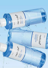 Three bottles of Medicube skincare product on a light blue background