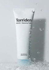 Torriden cleansing foam tube with water droplets on a light gray background