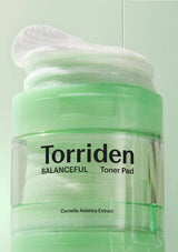 Torriden Balanceful Toner Pad container with toner on a light green background