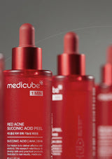 RedMedicube skincare product bottles on a gray background