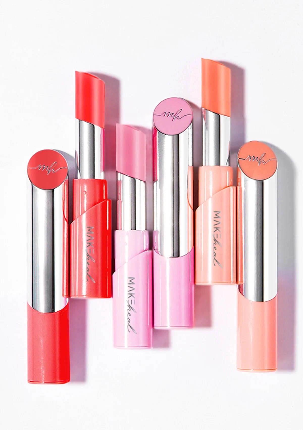 Set of colorful lipsticks with visible brand name on a white background