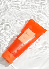 Orange bottle with a label on a textured white background