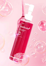 Medicube bottle on a pink background with bubbles