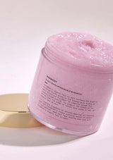 Pink jar of shampoo with text on a white background