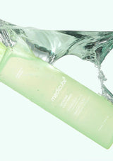 Green bottle with water splash on a white background