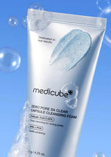 Tube of Medicube Zero Pore SA Clear Capsule Cleansing Foam against a blue background with bubbles.